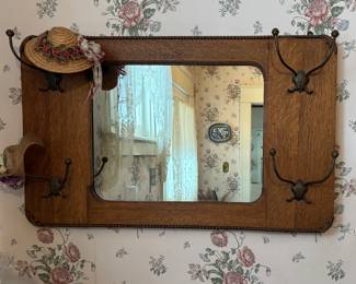 Hanging mirror with hat hooks