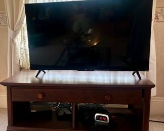 Roku TV and TV stand (sold separate) 