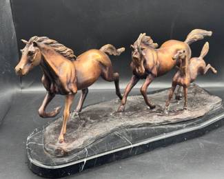 Metal Horses On Marble Slab
