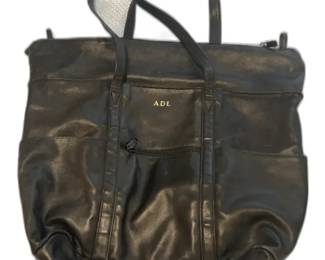 TUMI Black Leather Tote Bag with Monogram Outer pockets and one zippered interior pocket