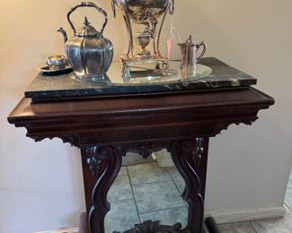 Late 1800s to early 1900s Victorian Gothic revival style mahogany hall piece with mirror and marble top.