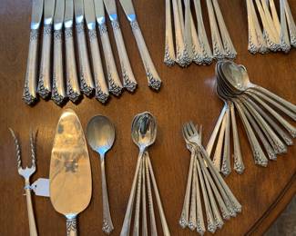#64 - $1,394. Heirloom Damask Rose set of sterling : 9 dinner knifes, 10 dinner forks, 8 salad forks, 12 spoons, 8 apetizers forks, 6 ice tea, 1 sugar spoon, 1 potato fork, 1 cake server = 47 pieces