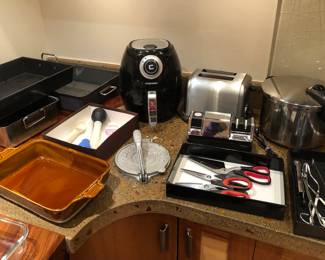 Roasting pans, Emile Henry brown baking dish, air fryer, Cuisinart toaster, tortilla press, Chef’s Choice knife sharpener, Duo pressure cooker, utensils 