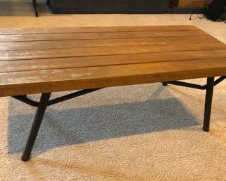 Wooden coffee table with metal legs (50”L, 23.5”D, 17.5”H) - was used outdoors