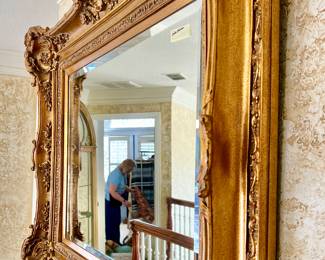 LARGE GOLD FRAMED BEVELED MIRROR.