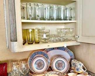 MEDITERRANEAN EVERYDAY PLACE SETTINGS WITH LOTS OF CRYSTAL AND GLASSWARE.