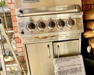DUCANE STAINLESS STEEL GAS GRILL WITH ROTISSERIE AND OTHER ATTACHMENTS.