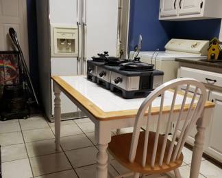 The white table has tile and maple top