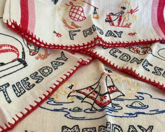 Four embroidered days of the week tea towels