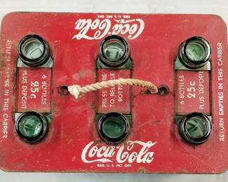 Vintage Coca-Cola glass bottles in tin antique holder