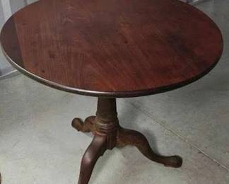 round solid wood table on a hinge pedestal legs 