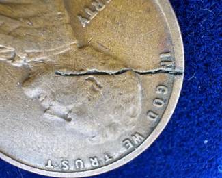 1928 Wheat cent with wire strike through mint error.  