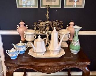 Another antique table with vintage treasures including fine China teapots and urns 