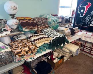 TABLES FULL OF BLANKETS, THROWS, LINENS