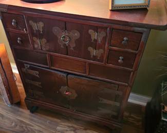 The butterfly Asian cabinet measures 27 and 1/2 in by 12 in by 29 in tall