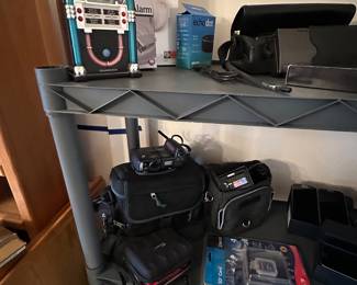 The jukebox up to the left is a radio alarm clock and works perfectly! The shelf below is filled with more cameras