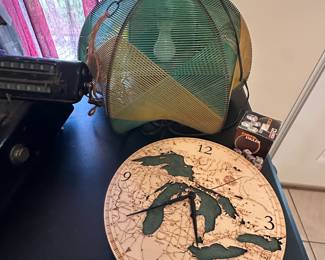 This pic has a terrific, modern, great lakes wall clock, and behind it is a terrific mid-century, modern hanging lamp