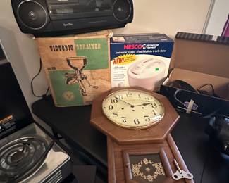 There are several like new stereo cassette players in the home. This is a beautiful wall, clock and other assorted items.