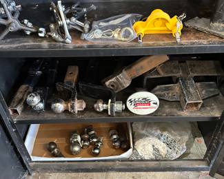 The bottom two shelves has trailer hitch balls, and accessories