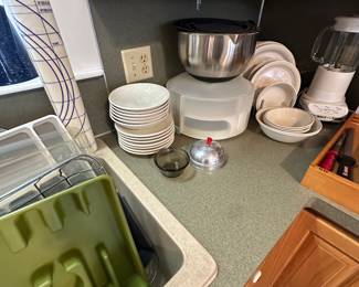 Dead center of the picture are some great vintage plates and bowls. I said of lid, stainless steel, mixing bowls, cupcake carrier, and a KitchenAid blender that has never been used.!
