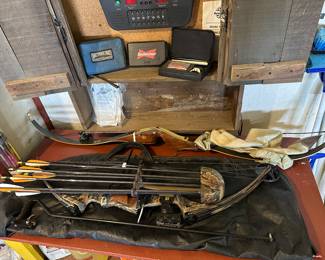 This table at the back of the garage is filled with bow hunting accessories.