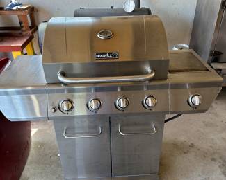 This is a fantastic and clean Nexgrill barbecue grill! A four flame grill with a burner on the side to the right! Comes complete with tank and cover. Also some utensils.
