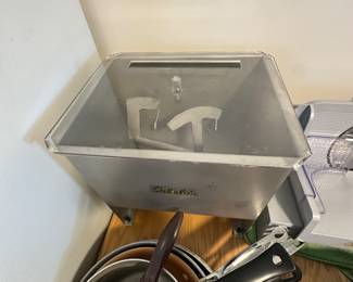 Sitting right next to it is a Cabela sausage stuffer which again looks near mint possibly never used! At the bottom of the picture are assorted frying pans, and and sauce pans!