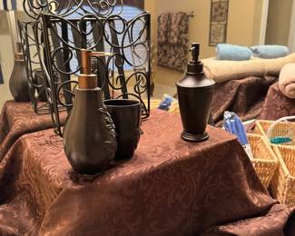 Scrolled toilet paper/ magazine rack, bronze and brown bath accessories and towels