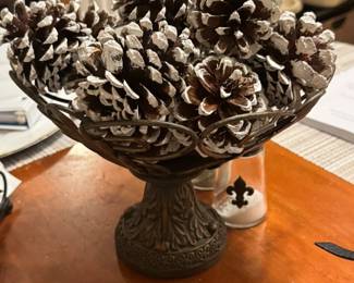 Scrolled metal dish with frosted pine cones