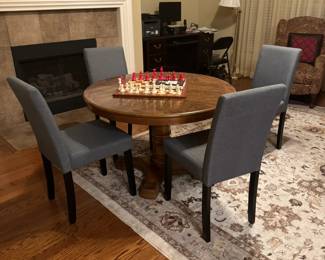 Small gaming table with one leaf. Round or oval shape. Four padded chairs- small and lightweight. Neutral beige area carpet