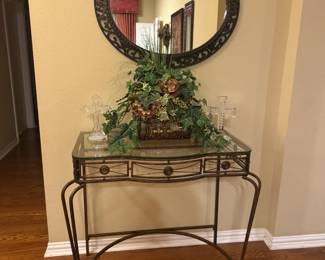 Glass top wrought iron console table, large oval mirror and pretty artificial arrangement