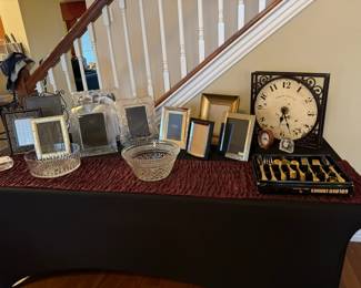 Waterford picture frame, Towle frames, numerous table and wall clocks, gold silverware set.