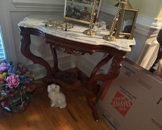 Antique Walnut Dog Table with Marble Top
Traditional Victorian design with the splayed legs and scalloped design as you like to see in a dog table. Both frame and beveled edge marble top in good condition with no cracks on the marble. Casters complete the frame for easy mobility. Measures 36" wide by 23" and 29" in height.