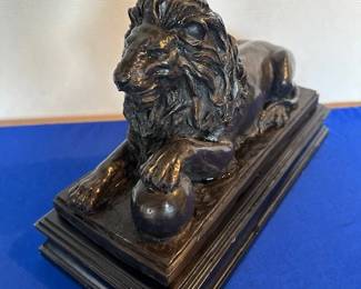 Vintage resin black lion on stand.