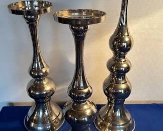 3 stainless Bombay Company candlesticks.