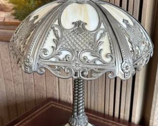 Tiffany-style table lamp with glass and ornate metal decor.