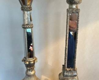 Tall ornate mirrored candlesticks.