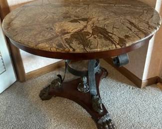 Iron and carved wooden base with granite top table.