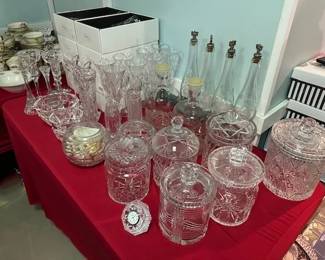 Crystal vases, candlesticks, champagne flutes, biscuit jars, bottles, and ice buckets.