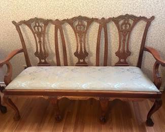 #105 Mahogany Chippendale triple seater settee, ball and claw, upholstered in cream satin fabric with damask.
