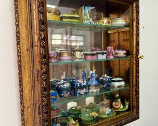 The gold curio cabinet is sold. The Limoges trinket boxes are available for purchase.