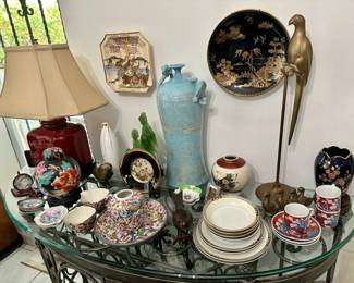 The brass parrot and tall blue vase are sold.