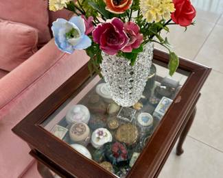 The glass vase and porcelain flowers are sold.