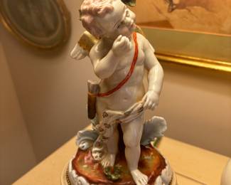 Close up of pair of antique cherub ceramic lamps 