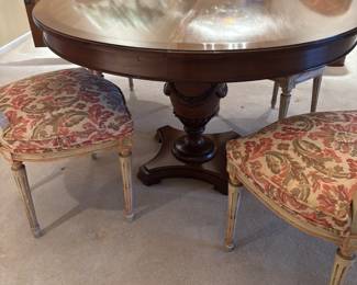 Vintage carved pedestal dining room table with leaf and pads , 4 newly upholstered chairs 