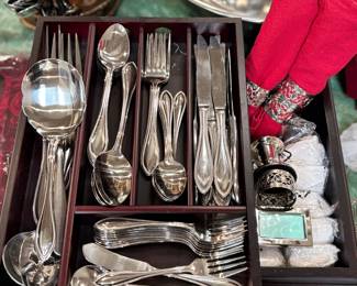 Silverware set with many accessories, including serving utensils, napkin rings, candle holders, place setting tags 