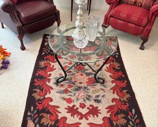 Rug, glass top wrought iron table, crystal vase, dish, candle holder