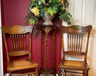 Two Cane Side Chairs With Pedestal Table And Floral Arrangement