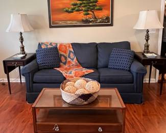 Great blue sleeper sofa, MCM art and coffee table.