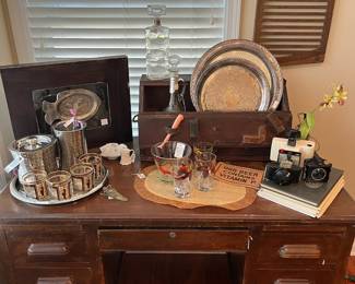 Nice classic wooden desk, antique wooden tool box, cameras and bar ware.
